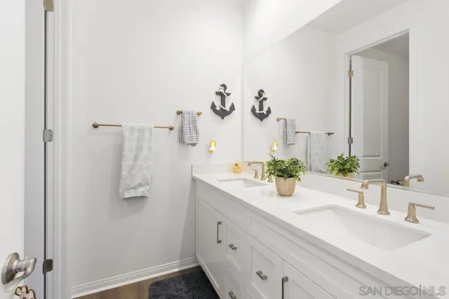 a bathroom with a double vanity sink and a mirror