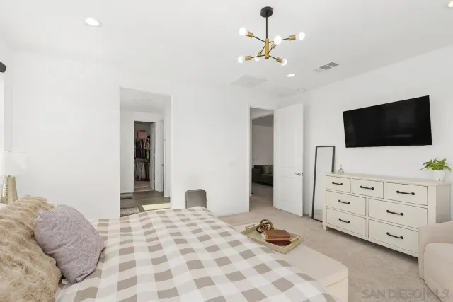 a bedroom with a bed and flat screen tv