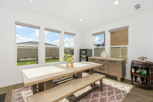 a room with pool table and windows