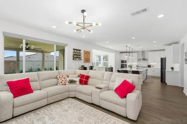 a living room with furniture and kitchen view