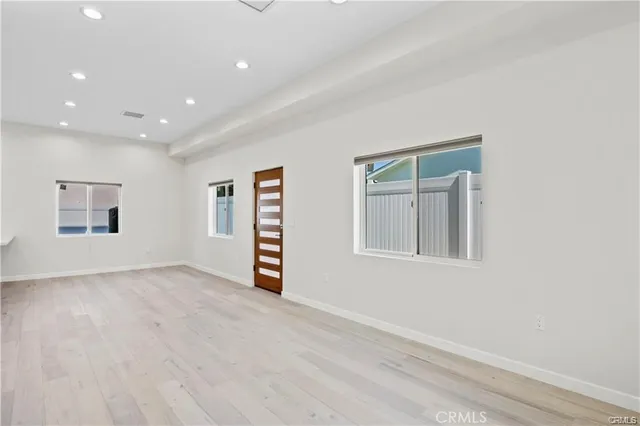 an empty room with windows and closet