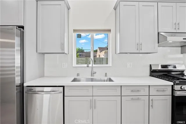 a kitchen with a sink cabinets and a window