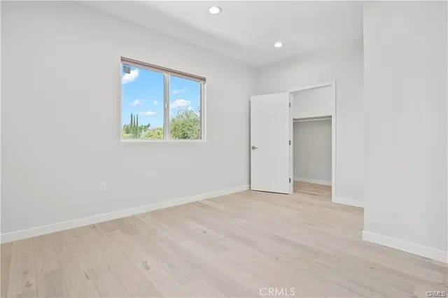 an empty room with windows and closet