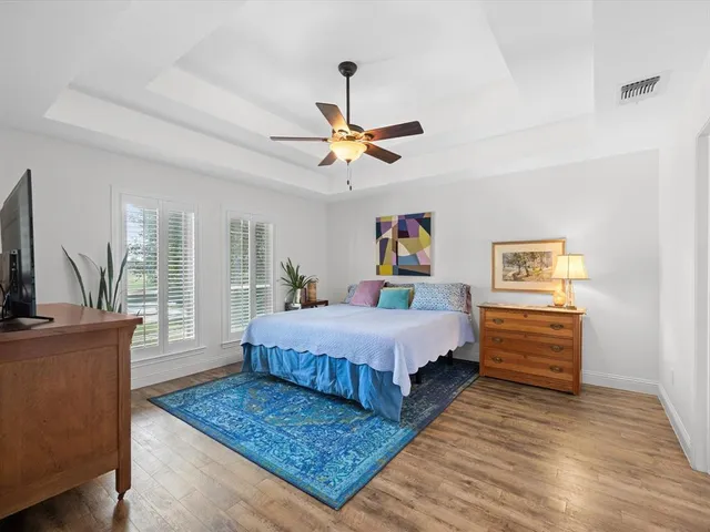 a bedroom with a bed dresser and a window