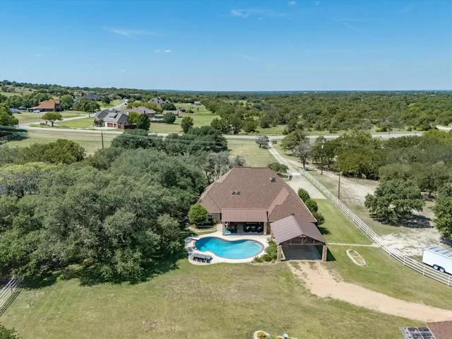an aerial view of a house with a yard