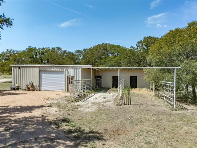 a backyard of a house with table and chairs