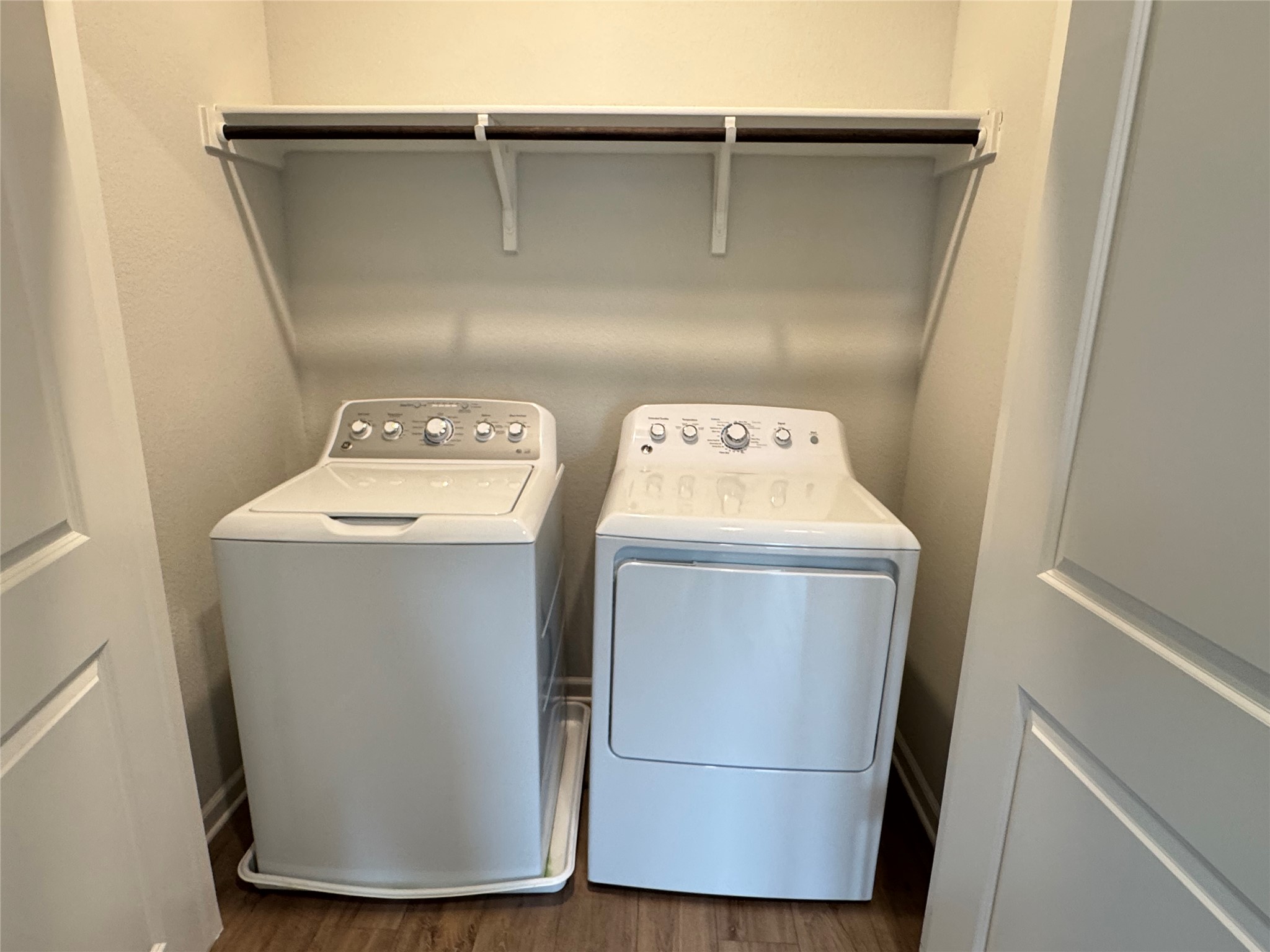 3000 Chisholm Trail Road, Unit 103 Round Rock, TX 78681 - Photo 29 of 32 Laundry area (second floor) featuring dark wood finished floors and independent washer and dryer