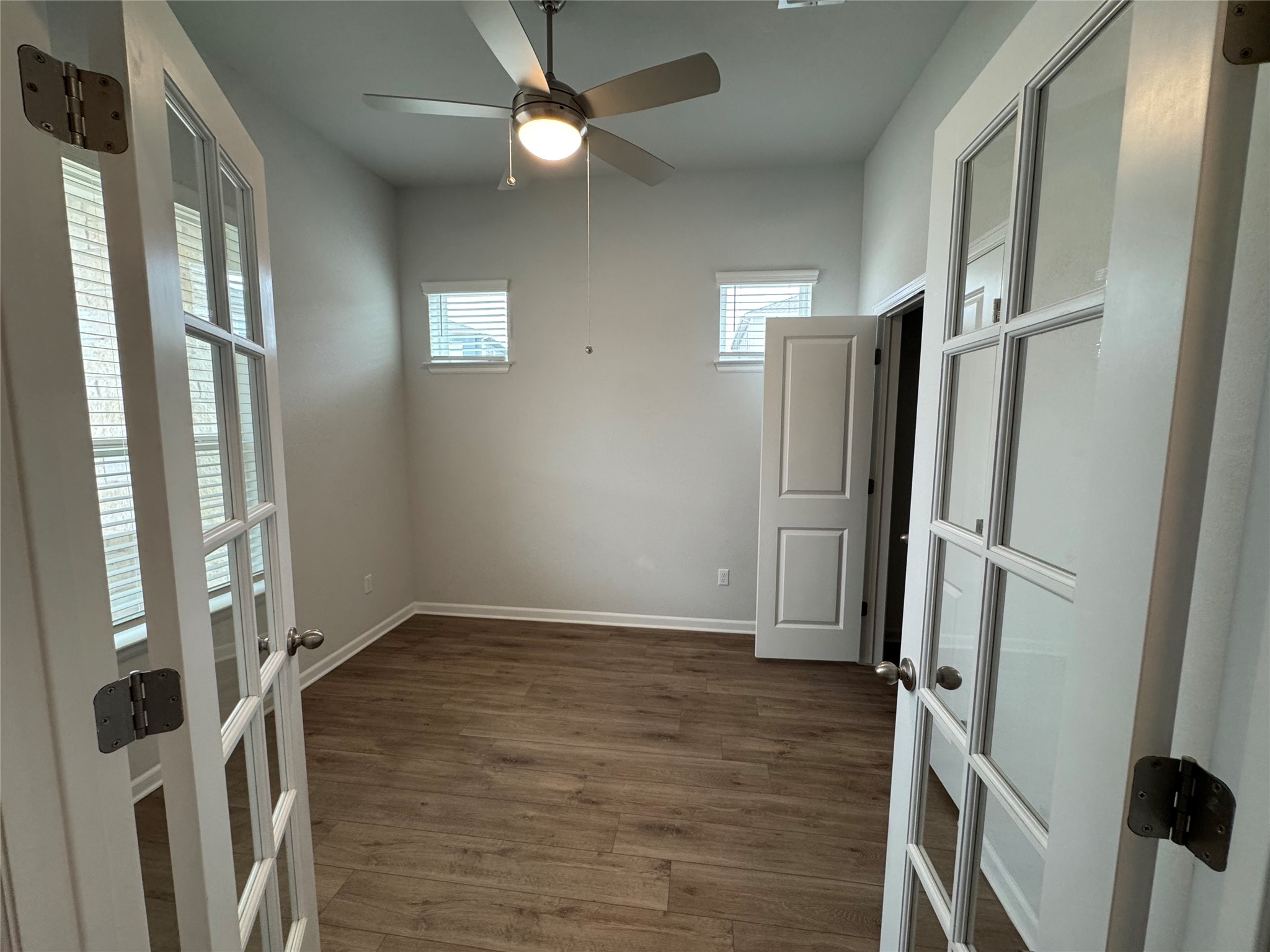 3000 Chisholm Trail Road, Unit 103 Round Rock, TX 78681 - Photo 3 of 32 a view of an empty room with wooden floor and a window