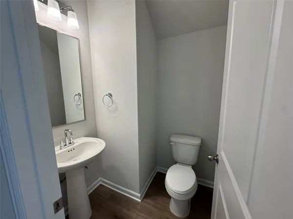 a white toilet sitting next to a bathroom sink