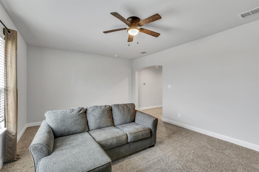 1306 Elizabeth Street Anna, TX 75409 - Photo 29 of 36 Living room with light carpet, arched walkways, and a ceiling fan