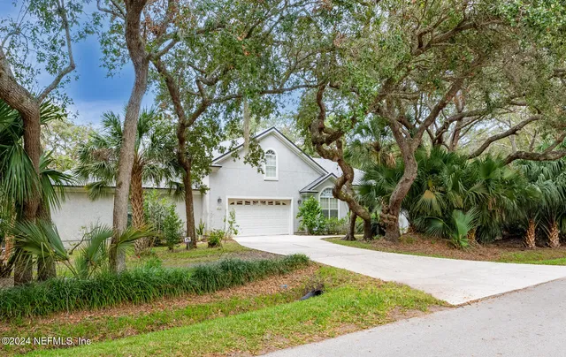 a living room with furniture a rug and a chandelier