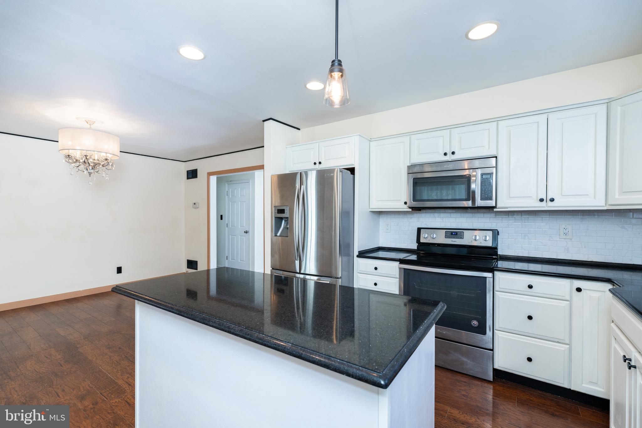 274 Birch Street Newark, DE 19711 - Photo 13 of 41 a kitchen with stainless steel appliances granite countertop a sink a stove and a refrigerator