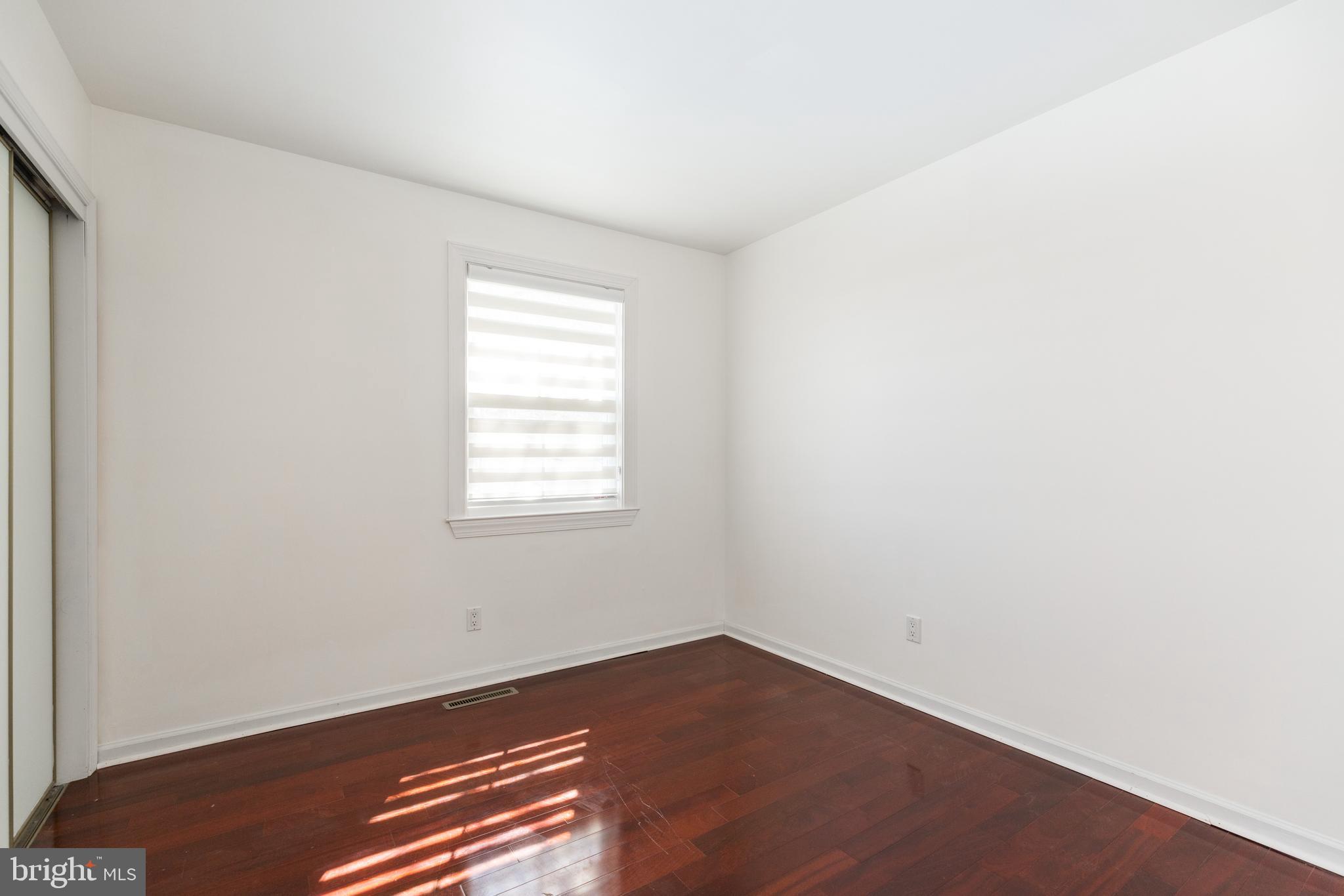 274 Birch Street Newark, DE 19711 - Photo 25 of 41 an empty room with wooden floor and windows