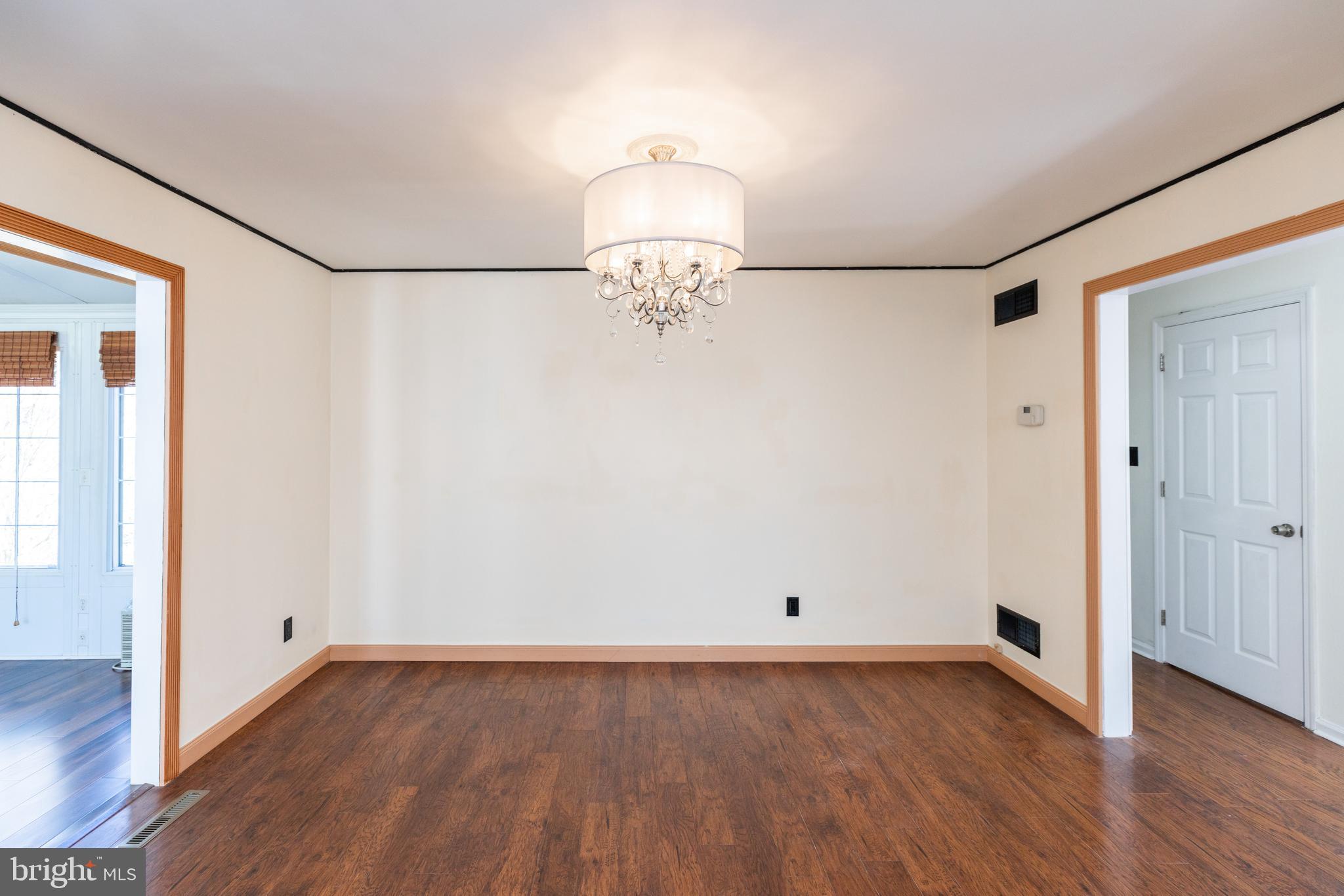 274 Birch Street Newark, DE 19711 - Photo 10 of 41 an empty room with wooden floor chandelier and windows