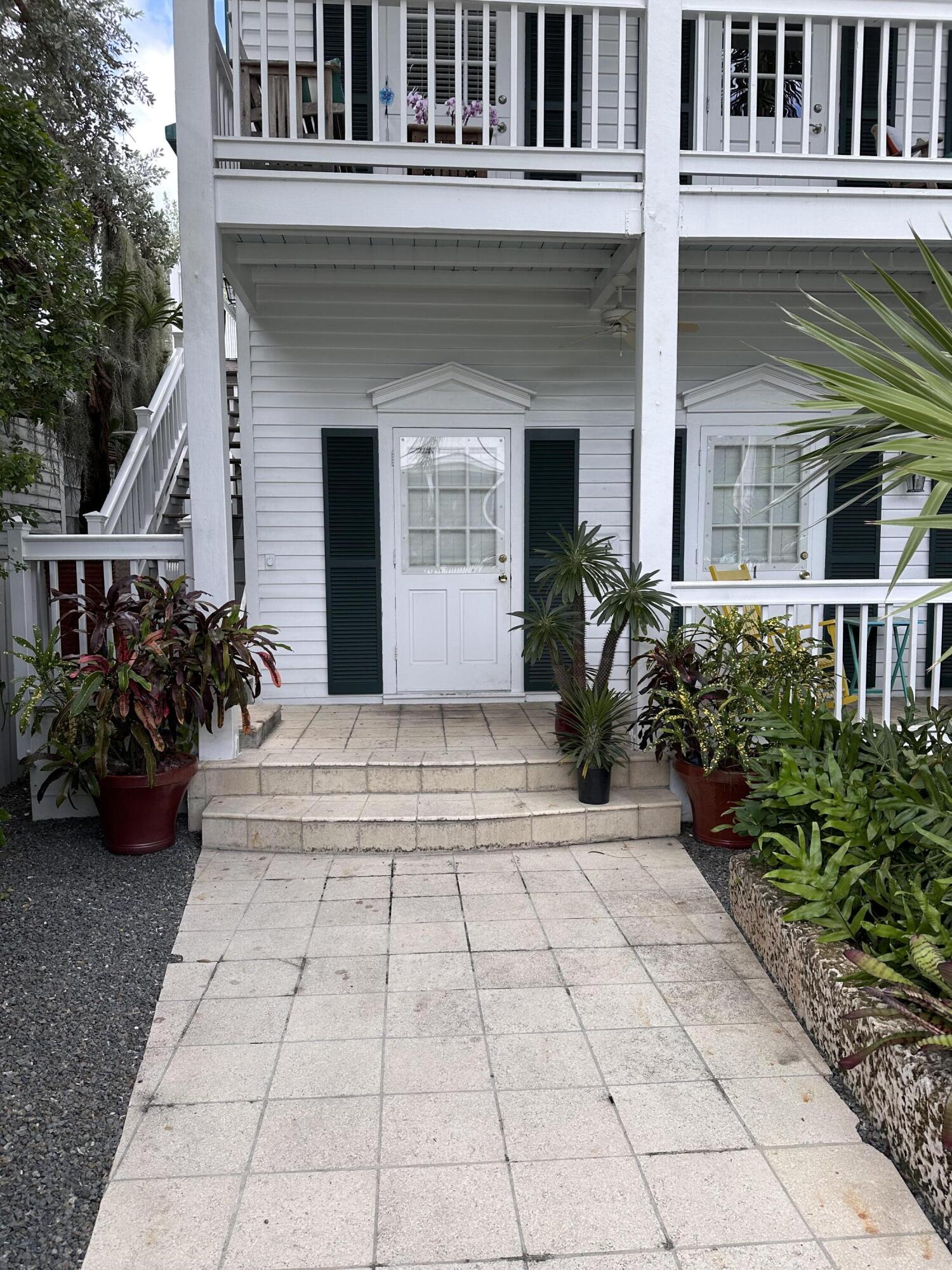 a view of a house with potted plants