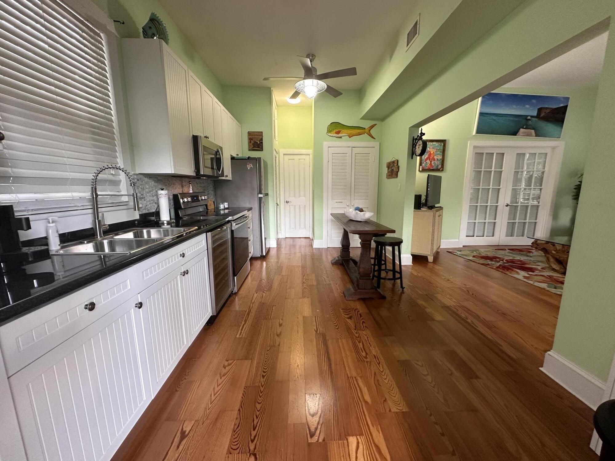 817 Eaton Street, Unit 1 Key West, FL 33040 - Photo 11 of 30 a large kitchen with lots of counter top space and wooden floor