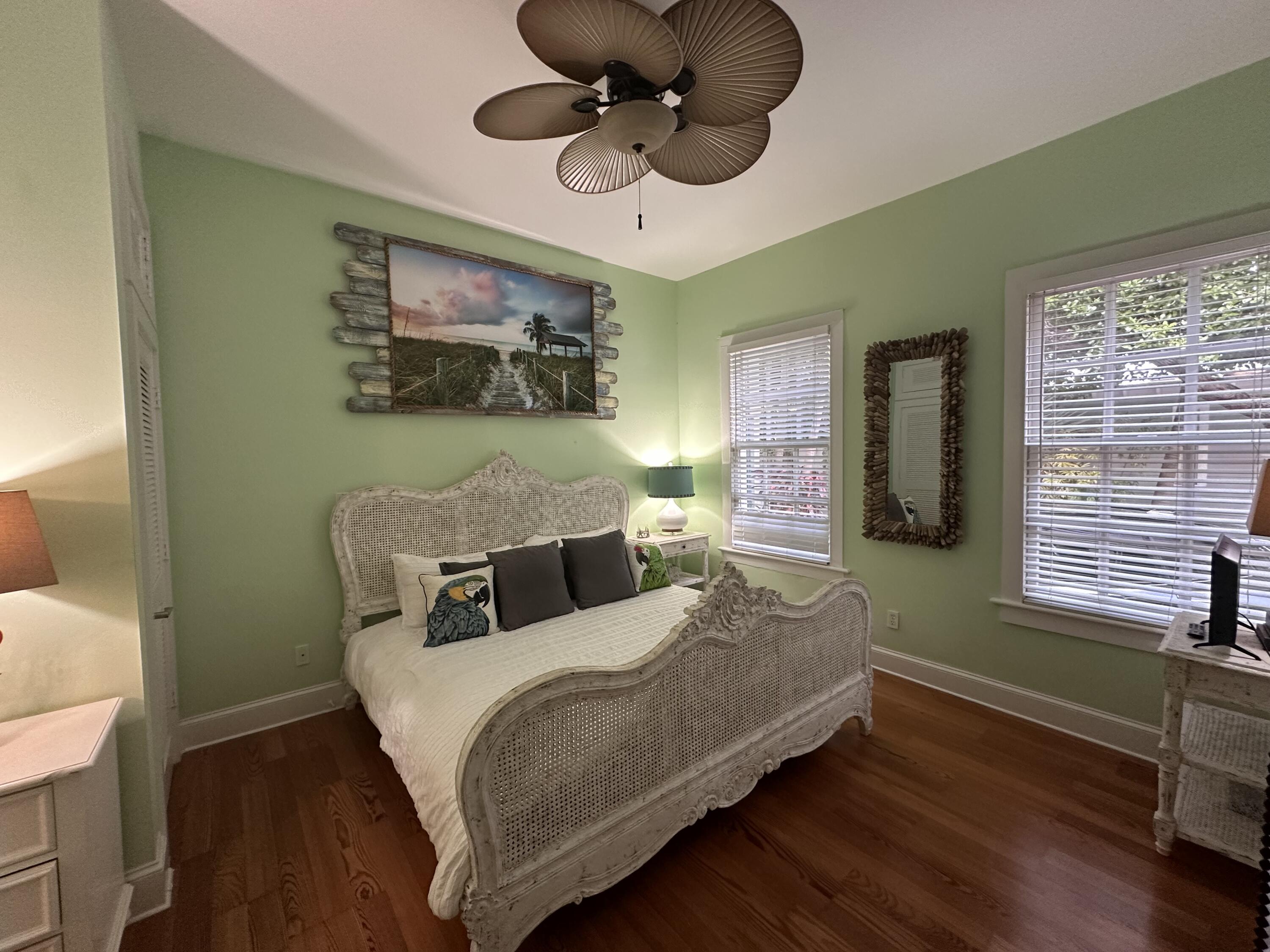 817 Eaton Street, Unit 1 Key West, FL 33040 - Photo 19 of 30 a bedroom with a bed chandelier and a window