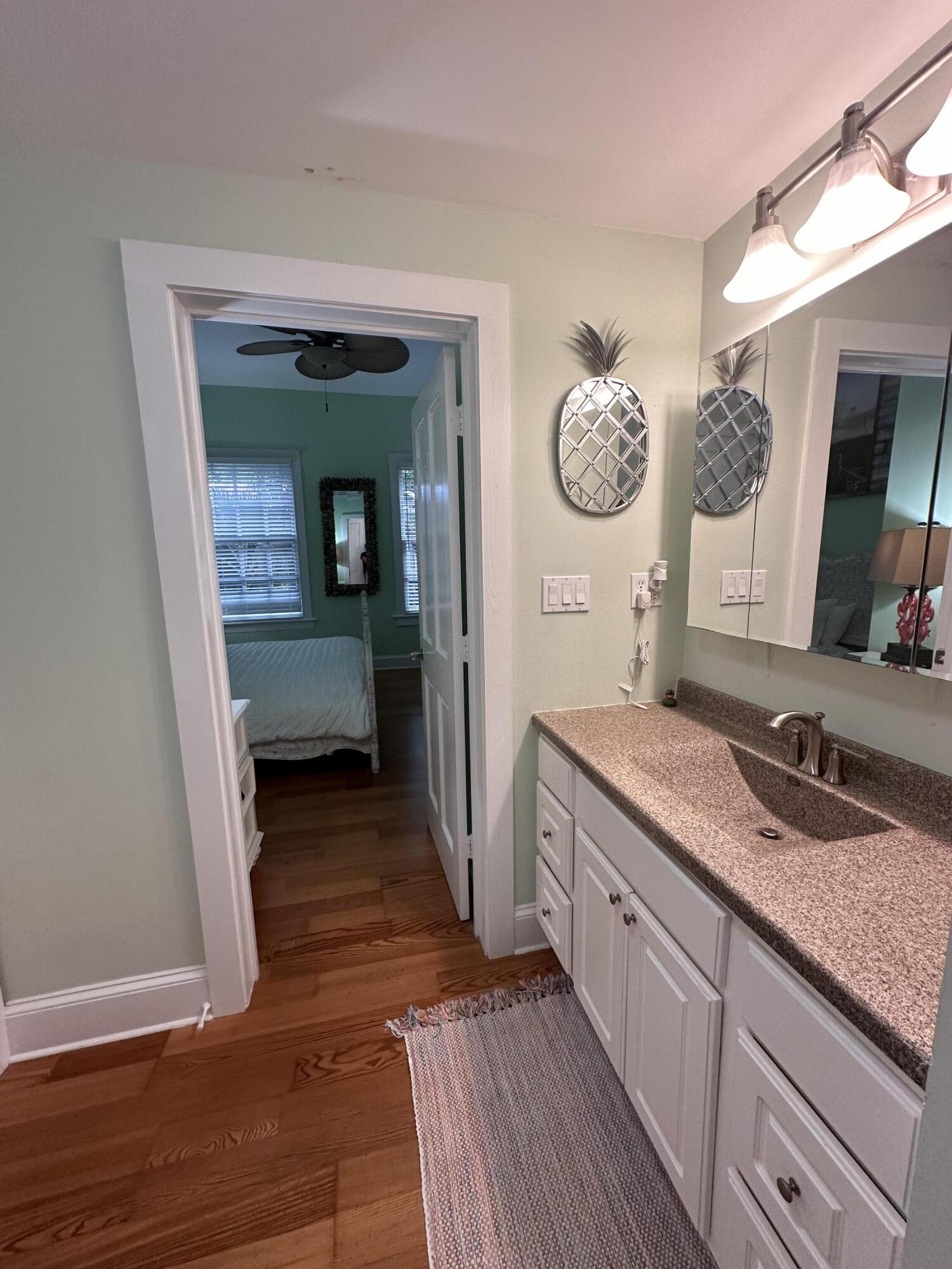 817 Eaton Street, Unit 1 Key West, FL 33040 - Photo 20 of 30 a en suite bathroom with a granite countertop sink and a mirror