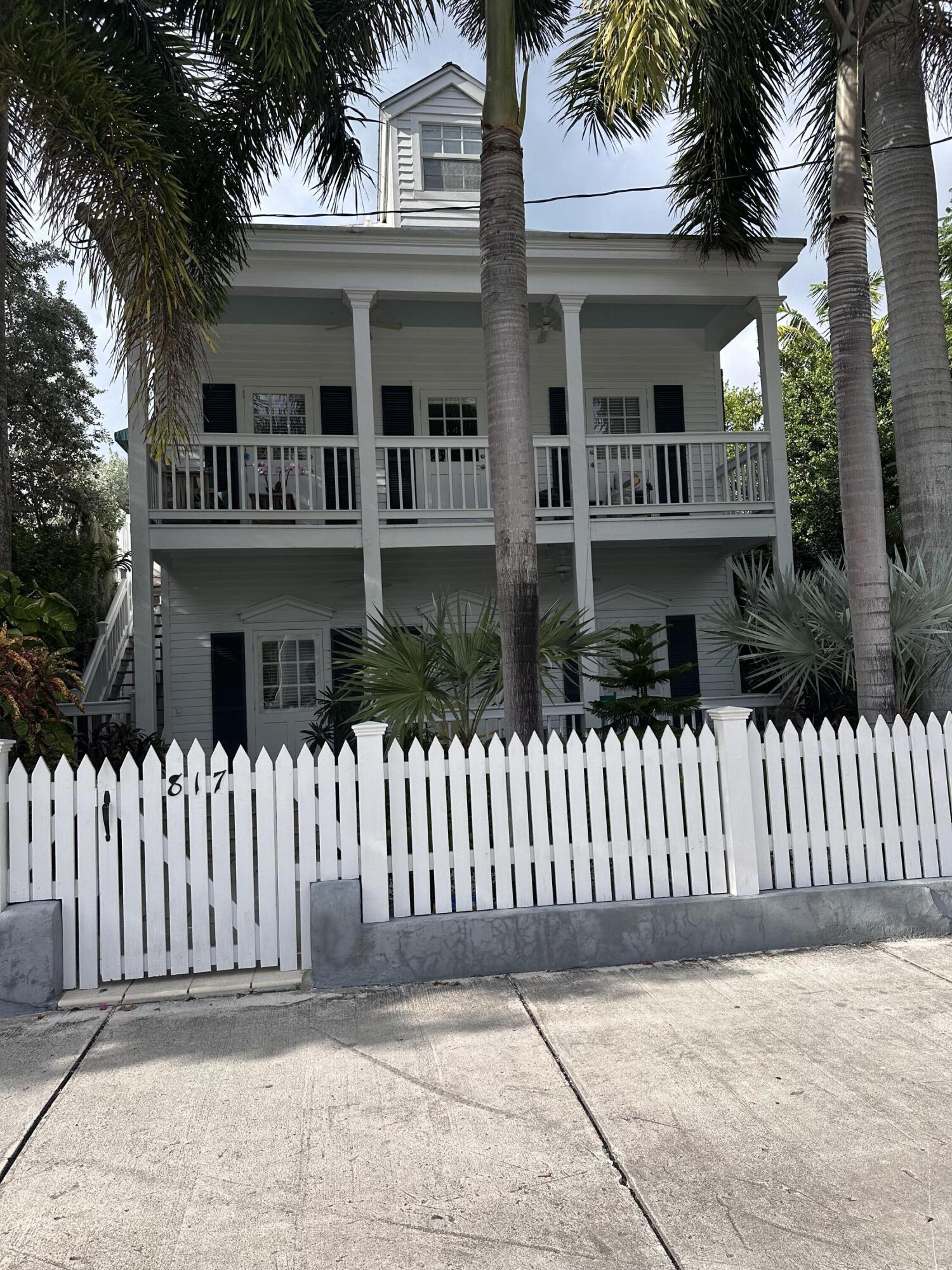 817 Eaton Street, Unit 1 Key West, FL 33040 - Photo 2 of 30 a front view of a house with a garden