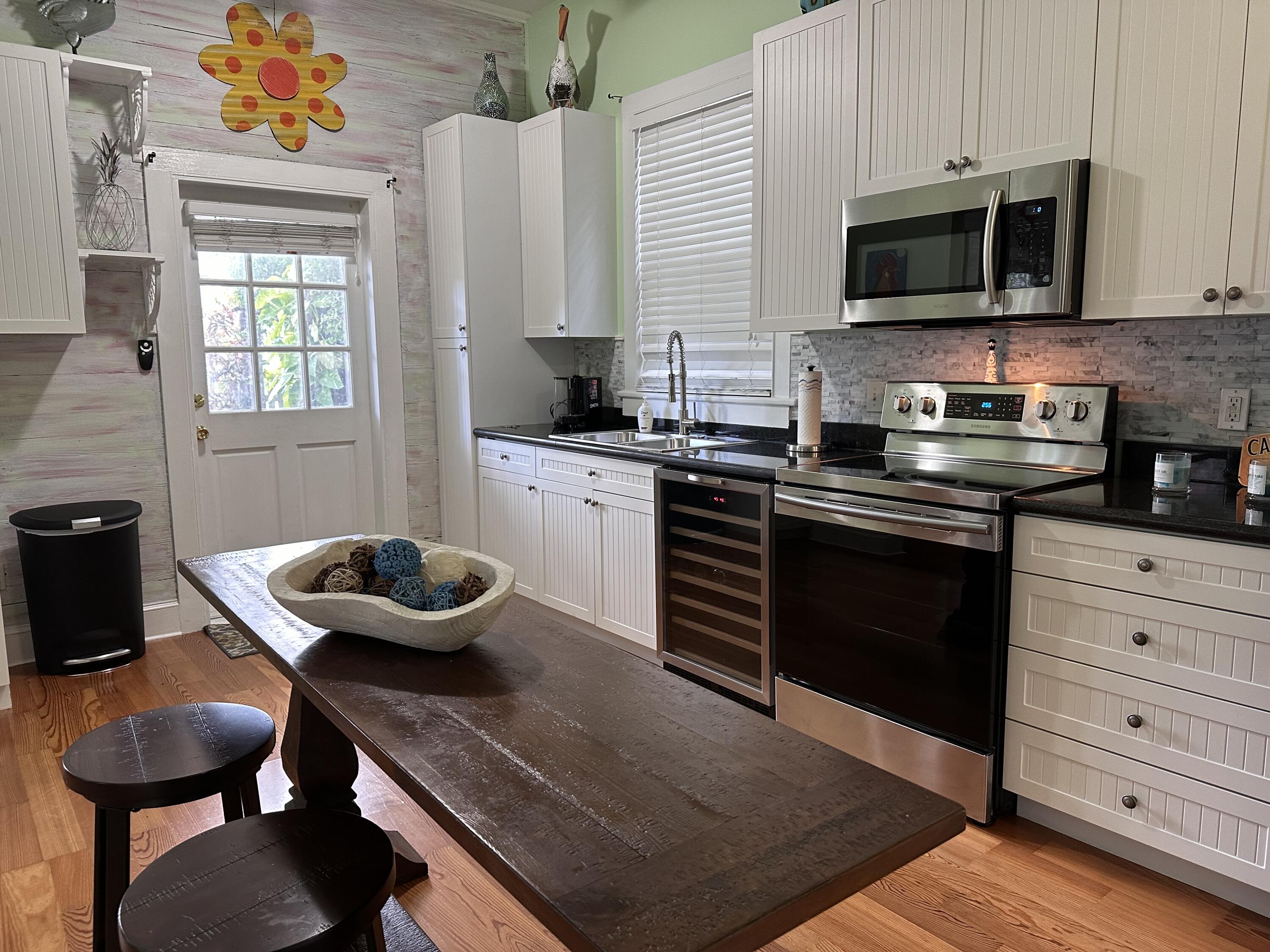 817 Eaton Street, Unit 1 Key West, FL 33040 - Photo 7 of 30 a kitchen with a stove and a microwave