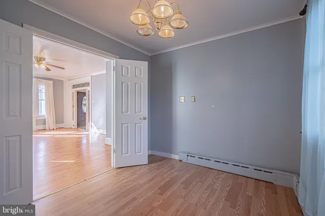 a view of a kitchen with a sink and wooden floor
