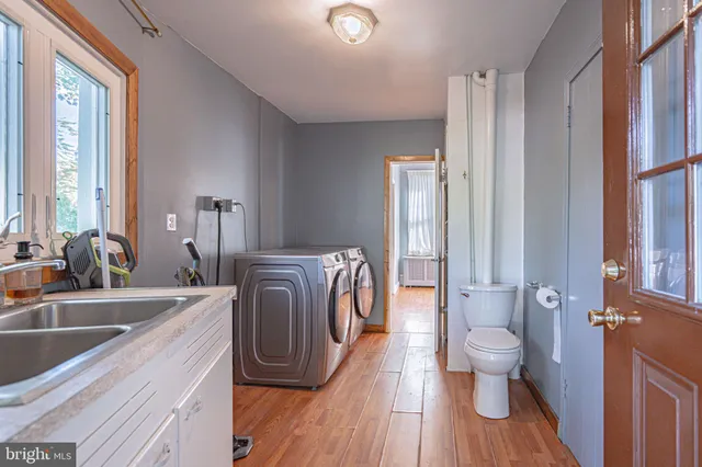 a view of a a dining room with furniture window and wooden floor
