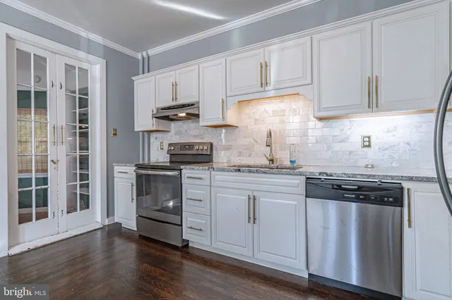 a bathroom with a double vanity sink toilet and shower