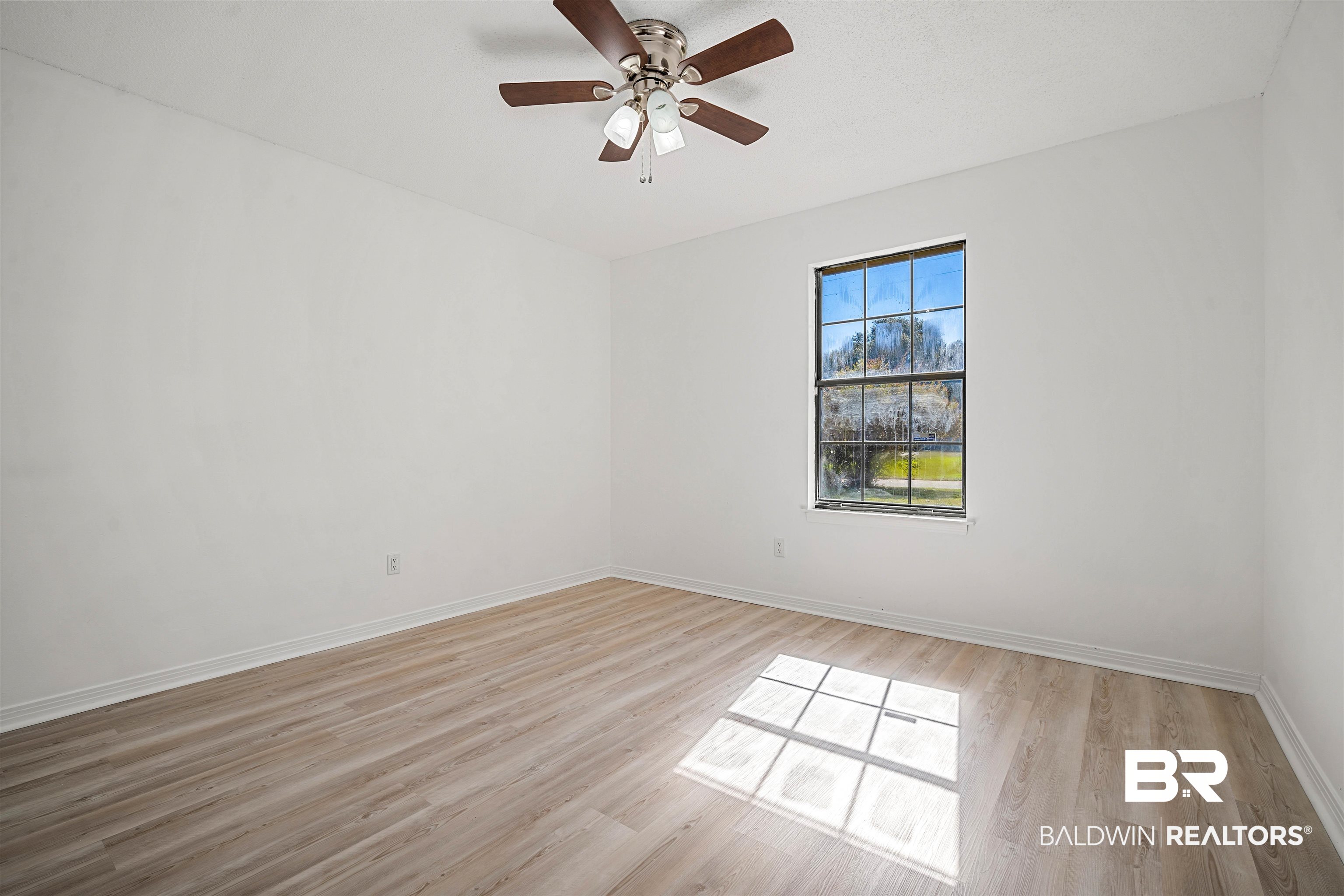 12910 Del Rio Street Grand Bay, AL 36541 - Photo 17 of 26 Empty room with light wood-style floors and ceiling fan