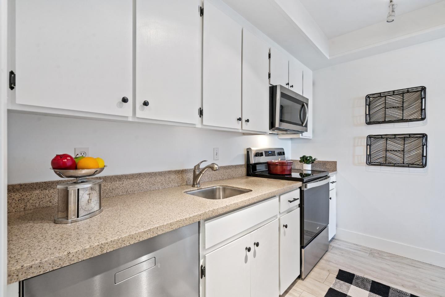 500 Almer Road, Unit 208 Burlingame, CA 94010 - Photo 17 of 30 a kitchen with stainless steel appliances granite countertop a sink stove and cabinets