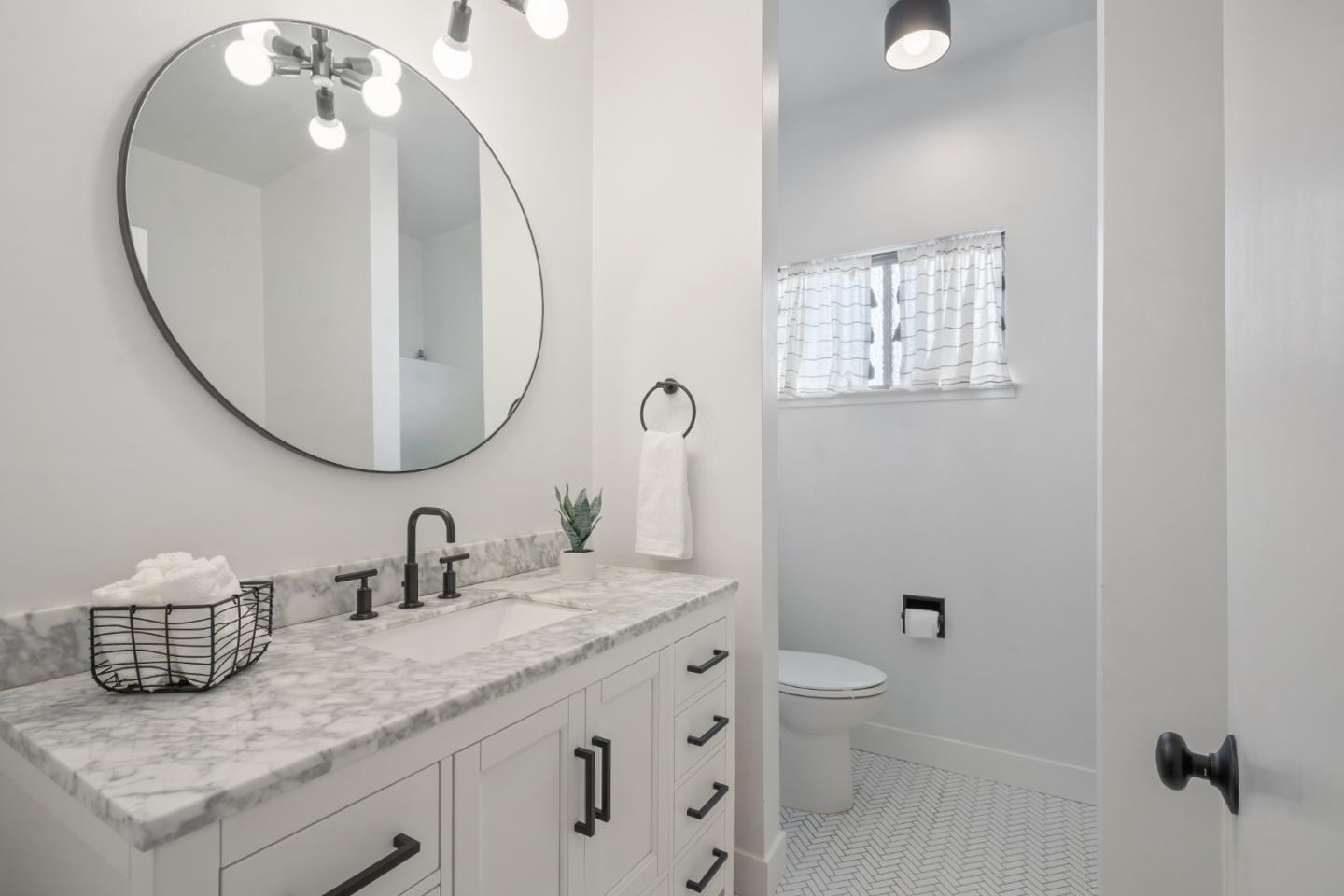 500 Almer Road, Unit 208 Burlingame, CA 94010 - Photo 19 of 30 a bathroom with a granite countertop sink a toilet and a mirror