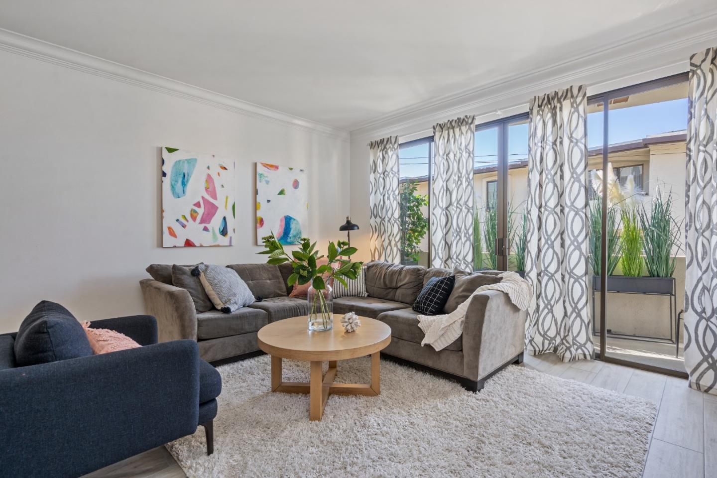 500 Almer Road, Unit 208 Burlingame, CA 94010 - Photo 10 of 30 a living room with furniture and a potted plant