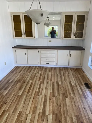 a view of a living room with wooden floor