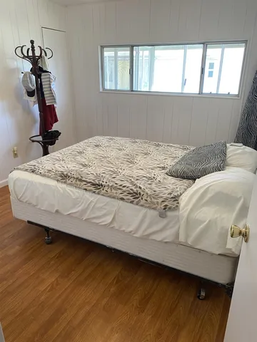 a bedroom with a bed and a window