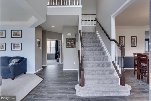 a view of entryway and hall with wooden floor