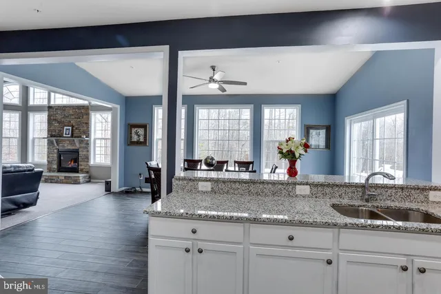 a living room with furniture a fireplace and a large window