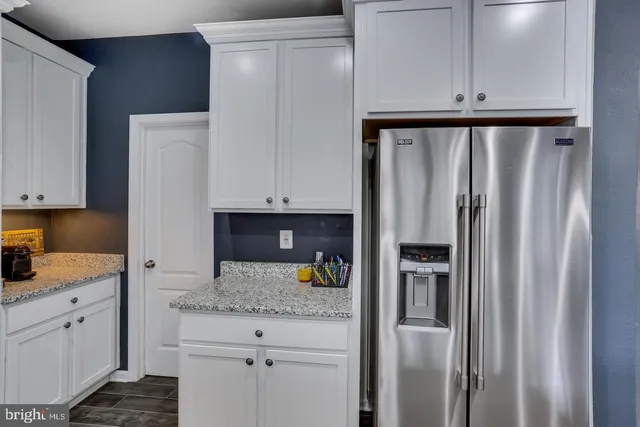 a kitchen with cabinets and window