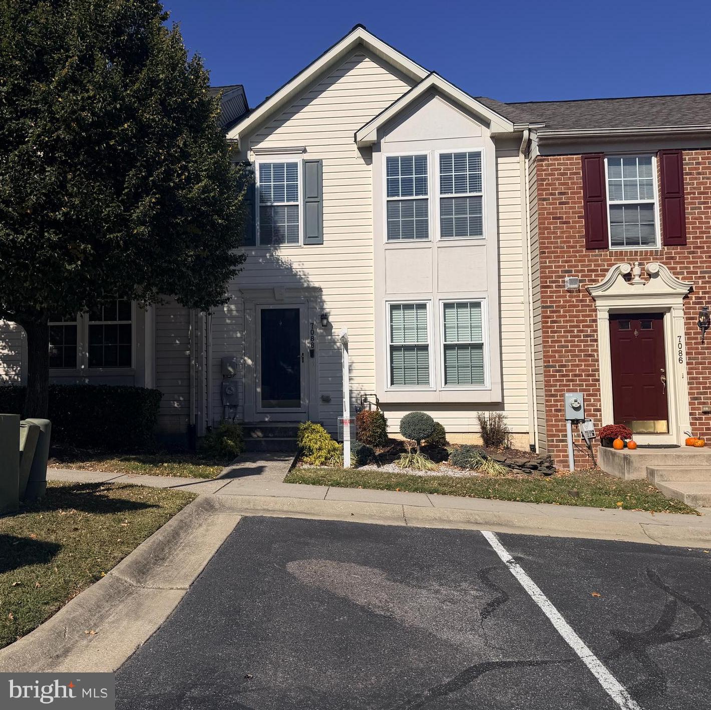 7088 Maiden Point Place, Unit 25 Elkridge, MD 21075 - Photo 1 of 29 a front view of a house with a yard