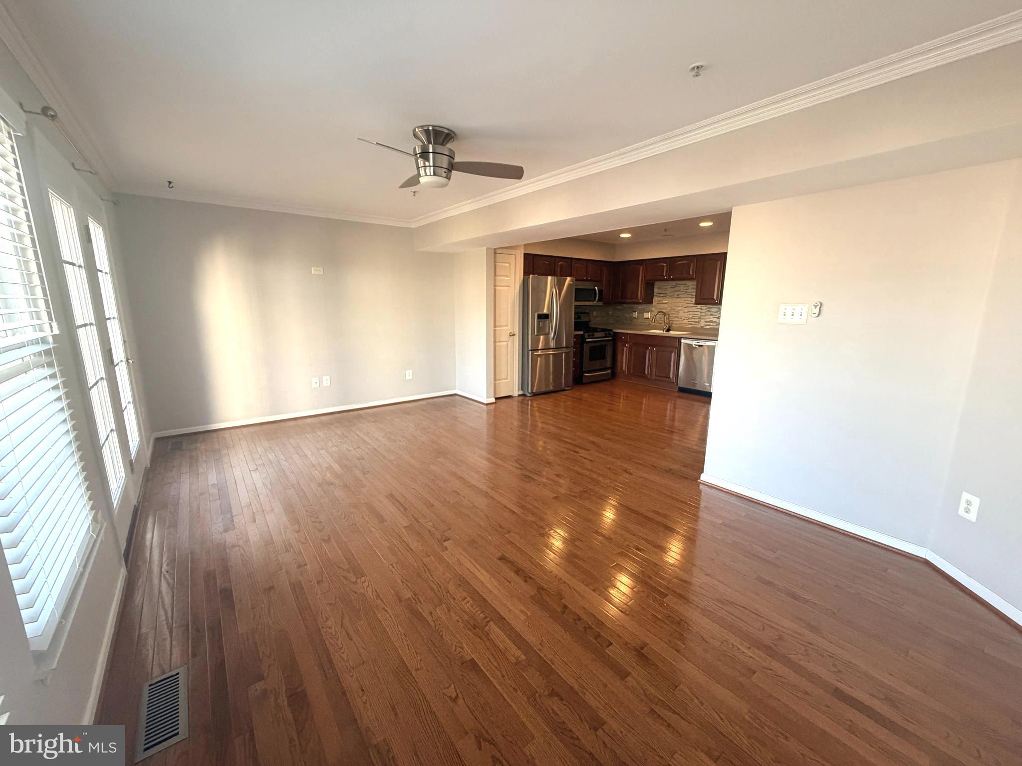7088 Maiden Point Place, Unit 25 Elkridge, MD 21075 - Photo 12 of 29 wooden floor in an empty room with a window