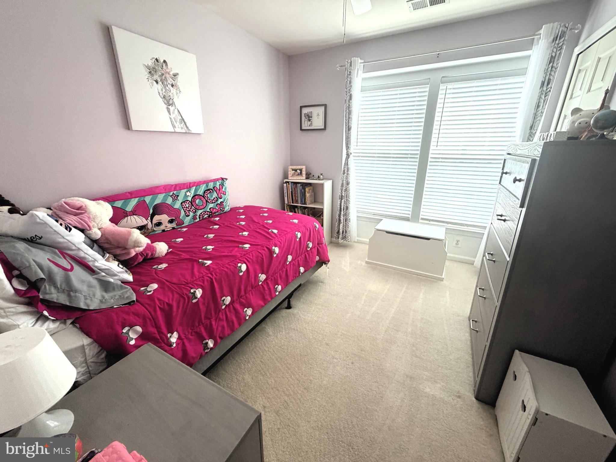 7088 Maiden Point Place, Unit 25 Elkridge, MD 21075 - Photo 15 of 29 a bedroom with a bed and wooden floor
