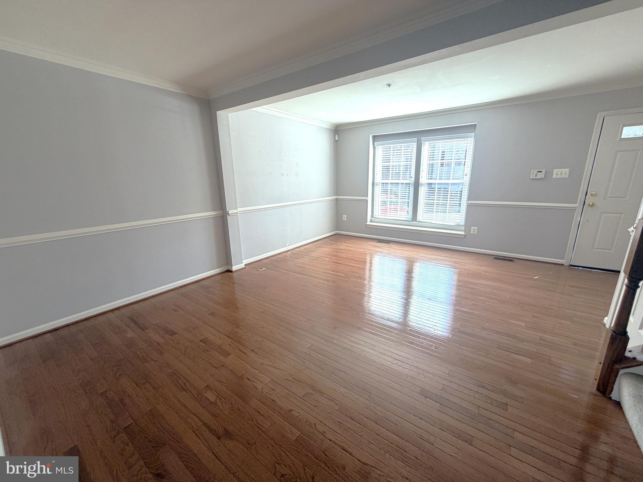 7088 Maiden Point Place, Unit 25 Elkridge, MD 21075 - Photo 2 of 29 an empty room with wooden floor and windows