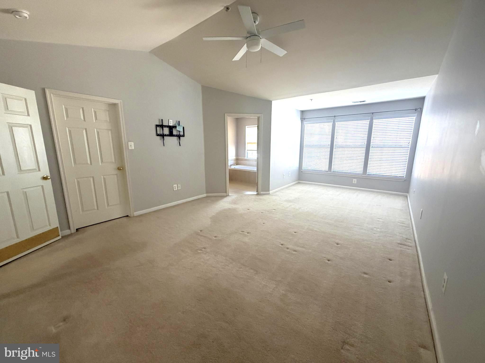 7088 Maiden Point Place, Unit 25 Elkridge, MD 21075 - Photo 22 of 29 an empty room with windows and closet