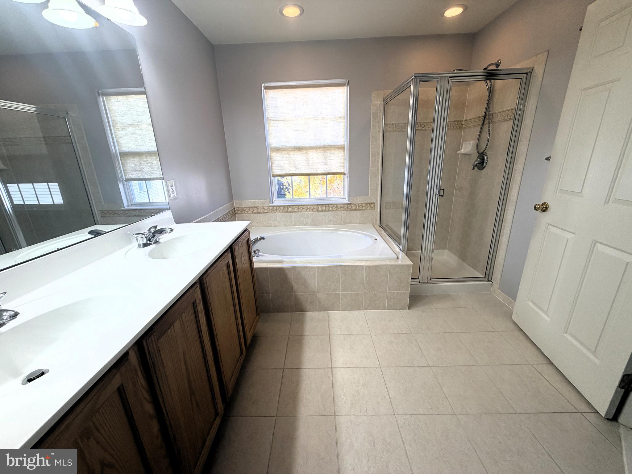 7088 Maiden Point Place, Unit 25 Elkridge, MD 21075 - Photo 24 of 29 a bathroom with a double vanity sink toilet and shower