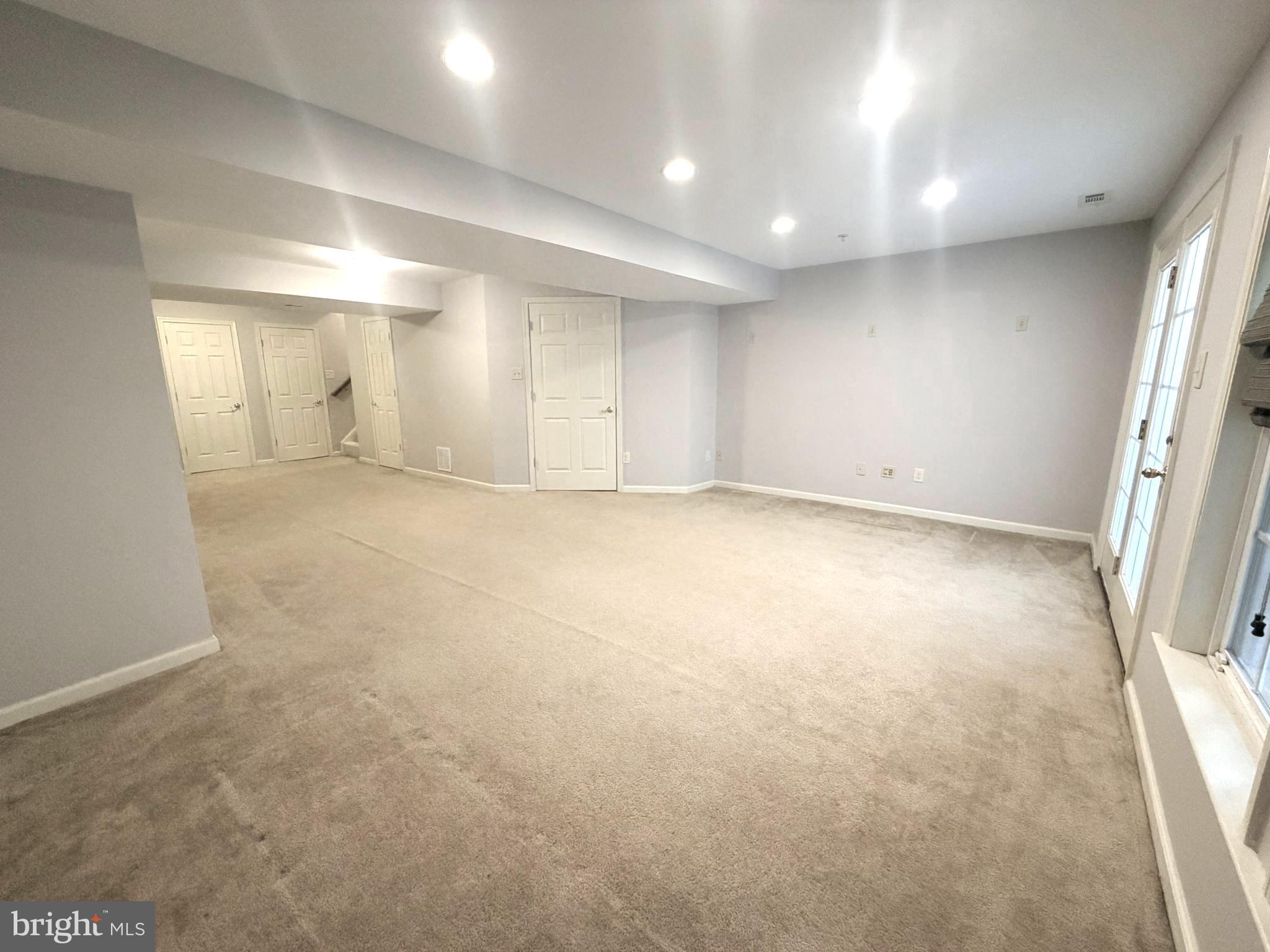 7088 Maiden Point Place, Unit 25 Elkridge, MD 21075 - Photo 27 of 29 an empty room with windows and entrance