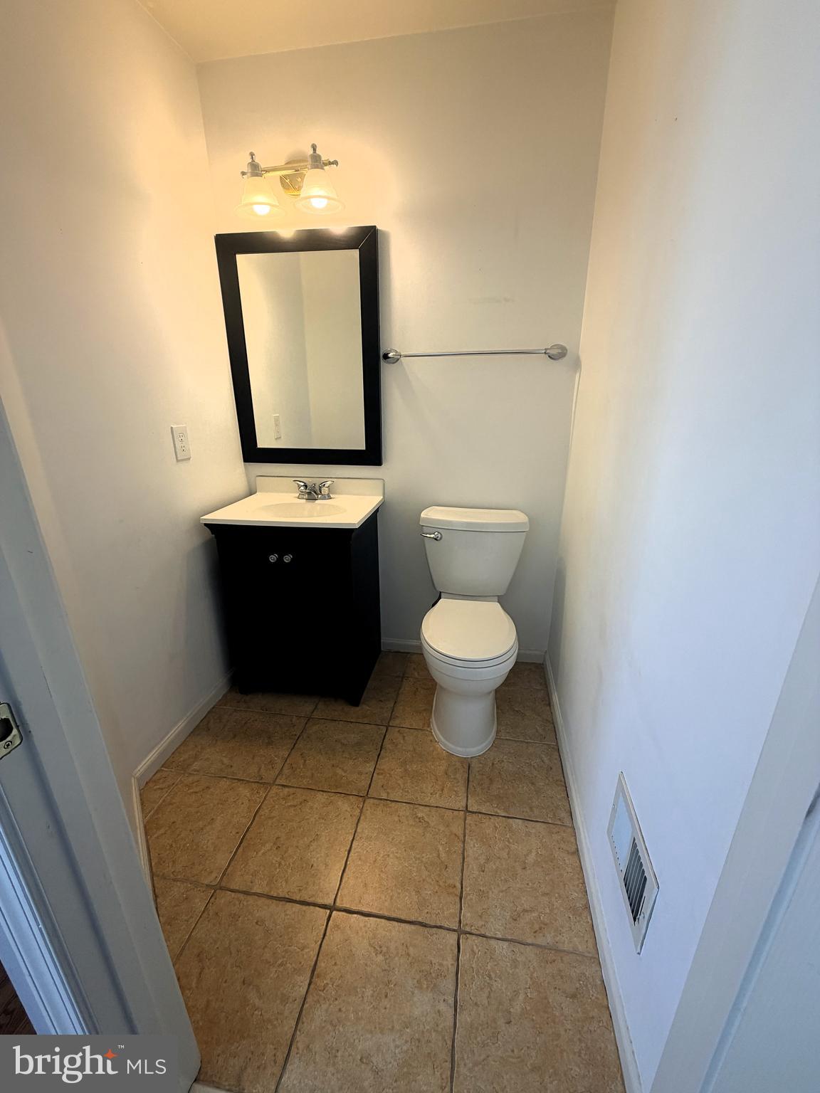 7088 Maiden Point Place, Unit 25 Elkridge, MD 21075 - Photo 5 of 29 a bathroom with a toilet a sink and mirror