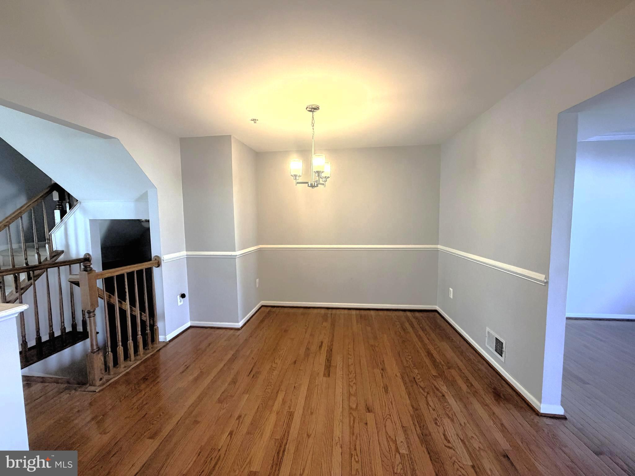 7088 Maiden Point Place, Unit 25 Elkridge, MD 21075 - Photo 9 of 29 wooden floor in an empty room with a window