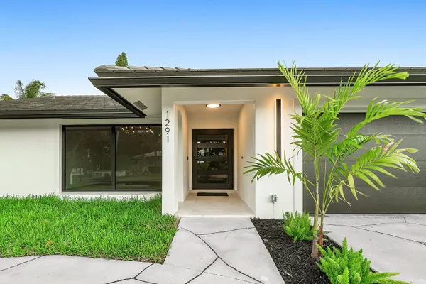 a front view of a house with a garden