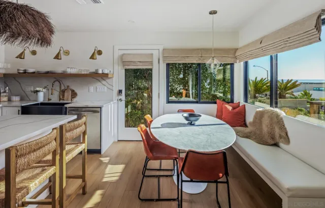 a dining room with furniture and a large window