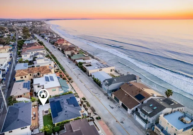 an aerial view of a city with ocean view