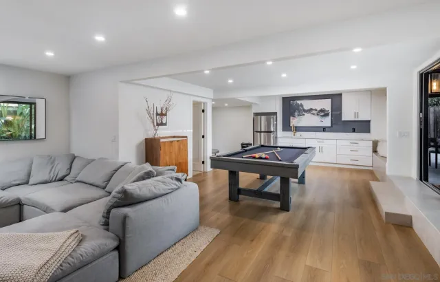 a room with pool table and windows