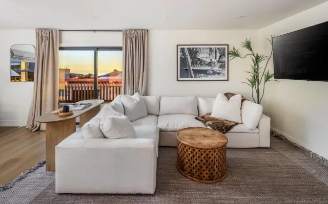 a living room with furniture and wooden floor